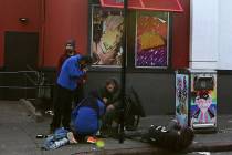 A group of men loiter and use drugs outside a fast food restaurant in the Tenderloin district o ...