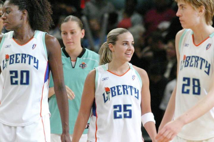 New York Liberty's Becky Hammon, second from right, smiles as teammates Shameka Christon, left ...