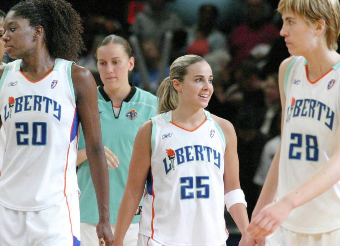 New York Liberty's Becky Hammon, second from right, smiles as teammates Shameka Christon, left ...