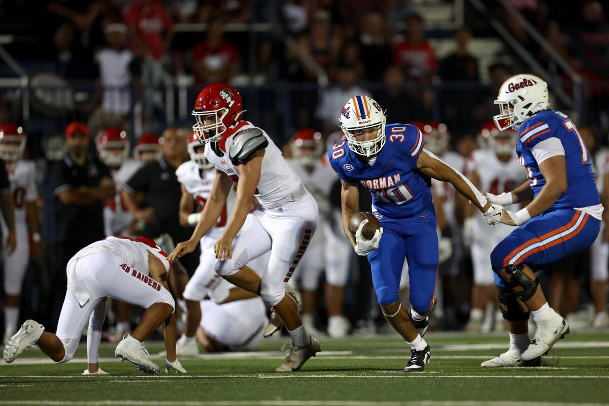 Bishop Gorman wide receiver Derek Meadows (30) advances with the ball after Kahuku failed to re ...