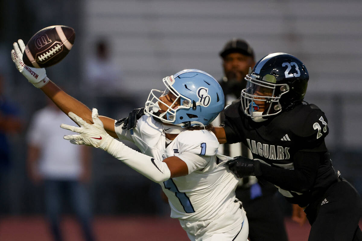 Desert Pines cornerback Miller Johnathan (23) thwarts a touchdown catch by Centennial wide rece ...