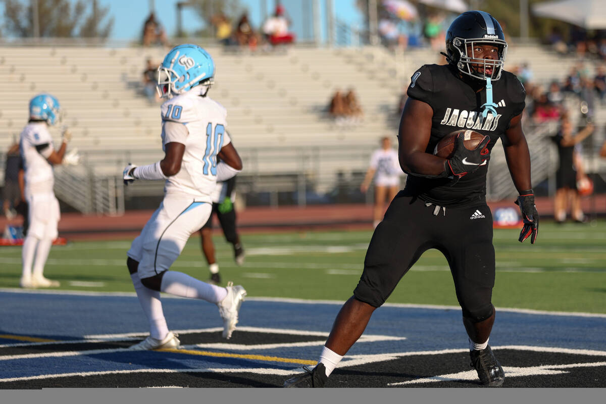 Desert Pines tight end Michael Taylor (9) scores a touchdown during the first half of a high sc ...