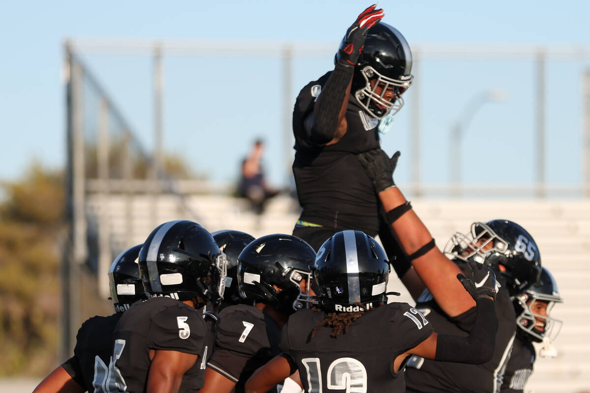 Desert Pines lifts tight end Michael Taylor after he scored a touchdown during the first half o ...