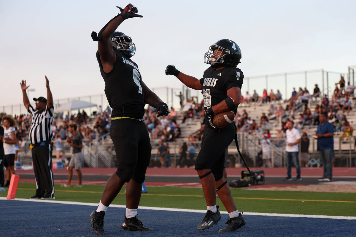 Desert Pines tight end Michael Taylor (9) and running back Isaiah Te'o (4) celebrate a touchdow ...