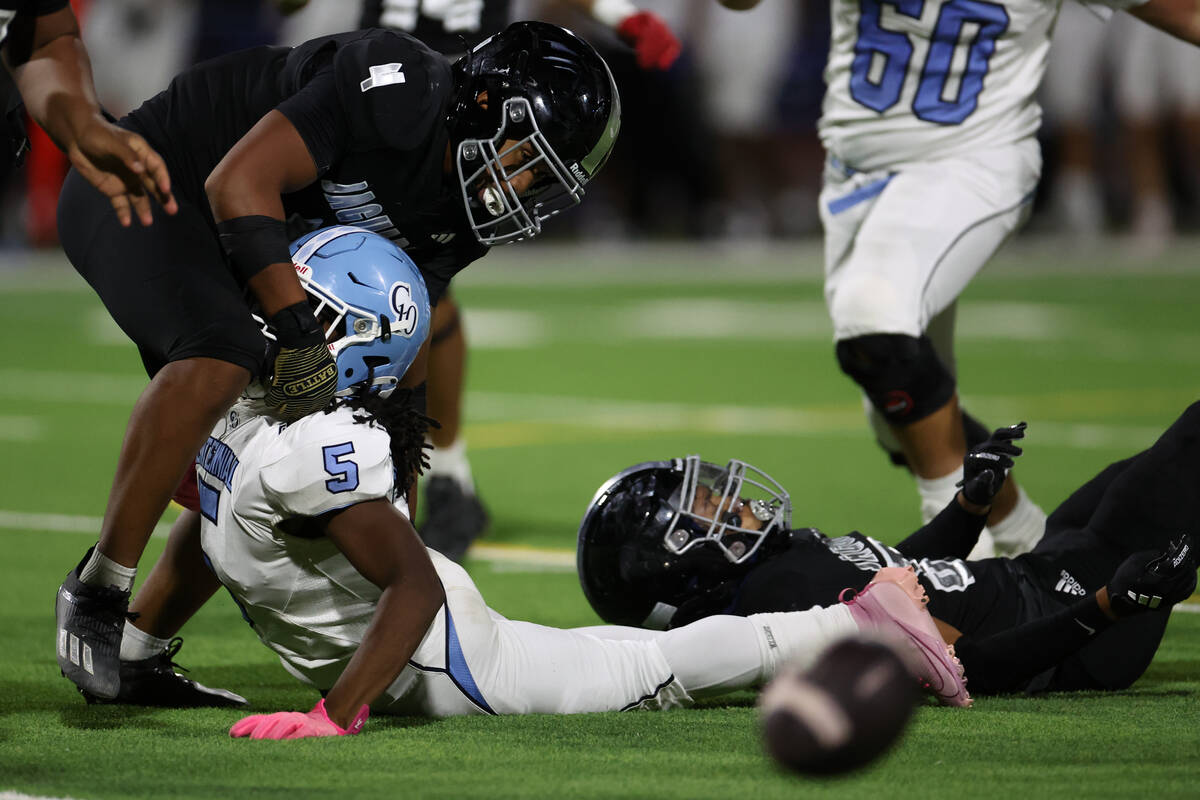 Centennial running back Khy Harris (5) fumbles the ball while Desert Pines linebacker Isaiah Te ...