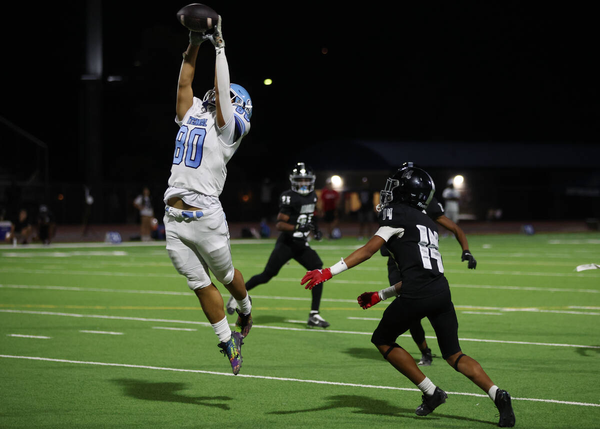 Centennial tight end Bailey Hucalo (80) jumps to catch while Desert Pines cornerback Jaisun Gil ...