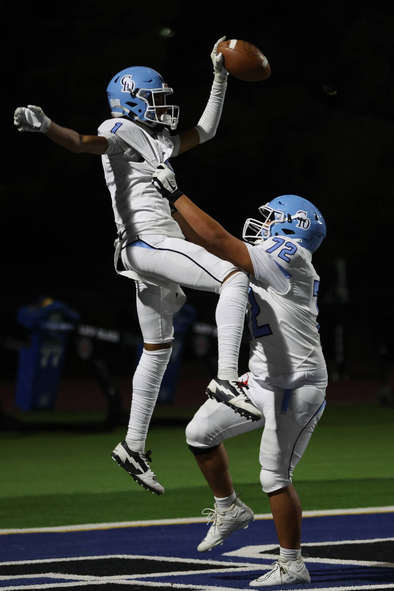 Centennial wide receiver Jayden "Jet" Thomas (1) celebrates with guard Joesiah Blazio ...