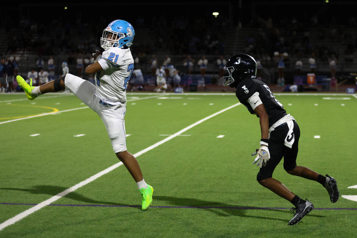 Centennial cornerback Dominique Vaughn (21) catches an interception while Desert Pines wide rec ...