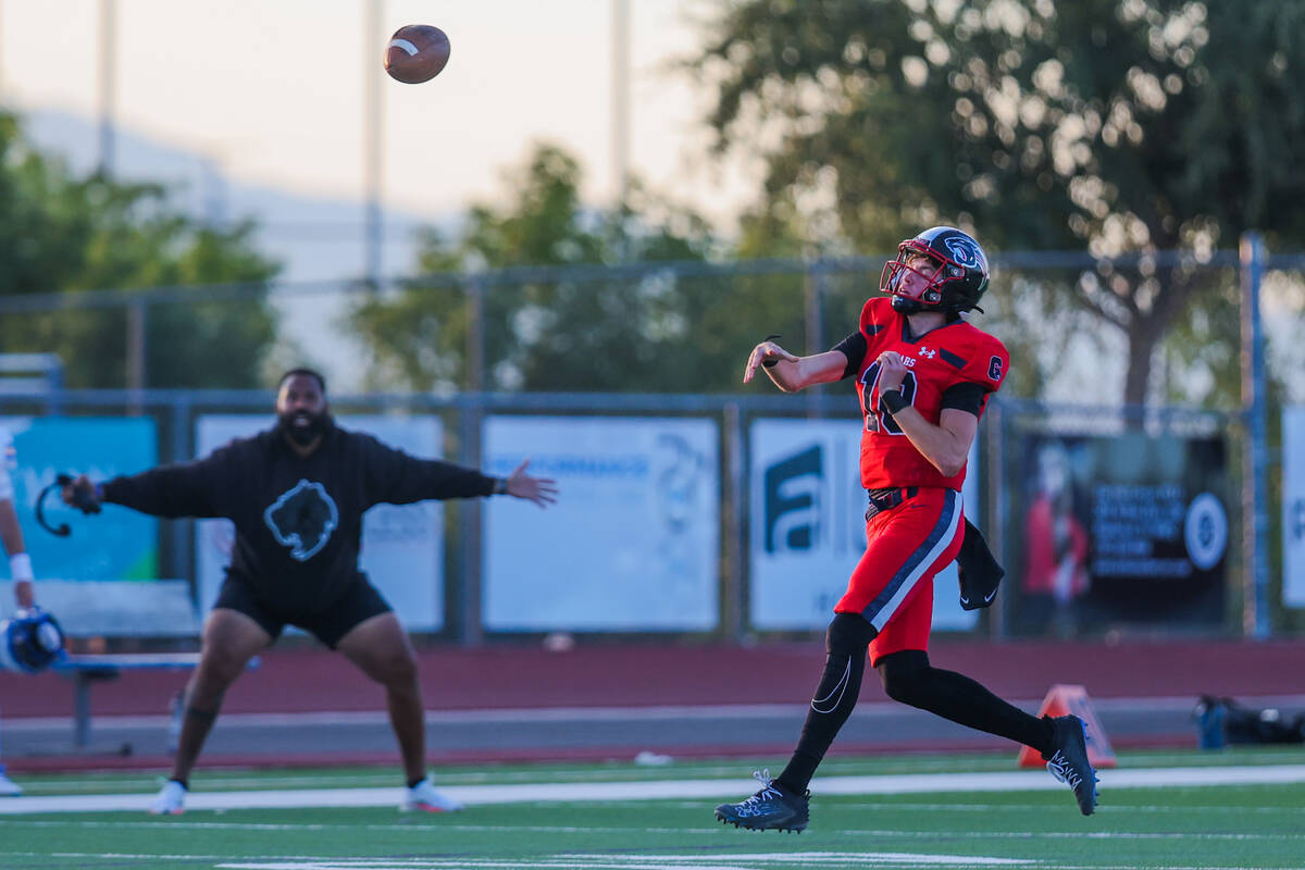 Coronado quarterback Aiden Krause throws the ball as Sierra Vista head coach Thomas Raybon gets ...