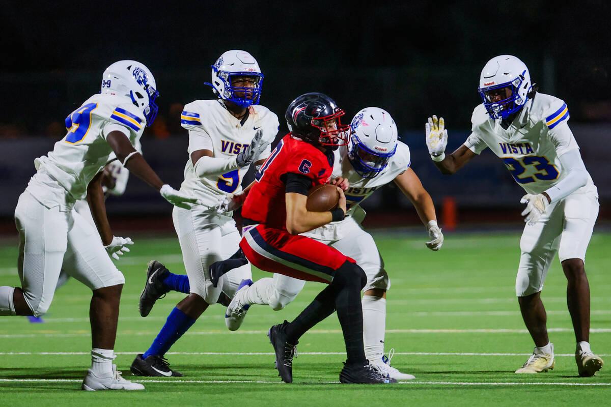 Coronado quarterback Aiden Krause (10) is surrounded by Sierra Vista defense as he runs the bal ...