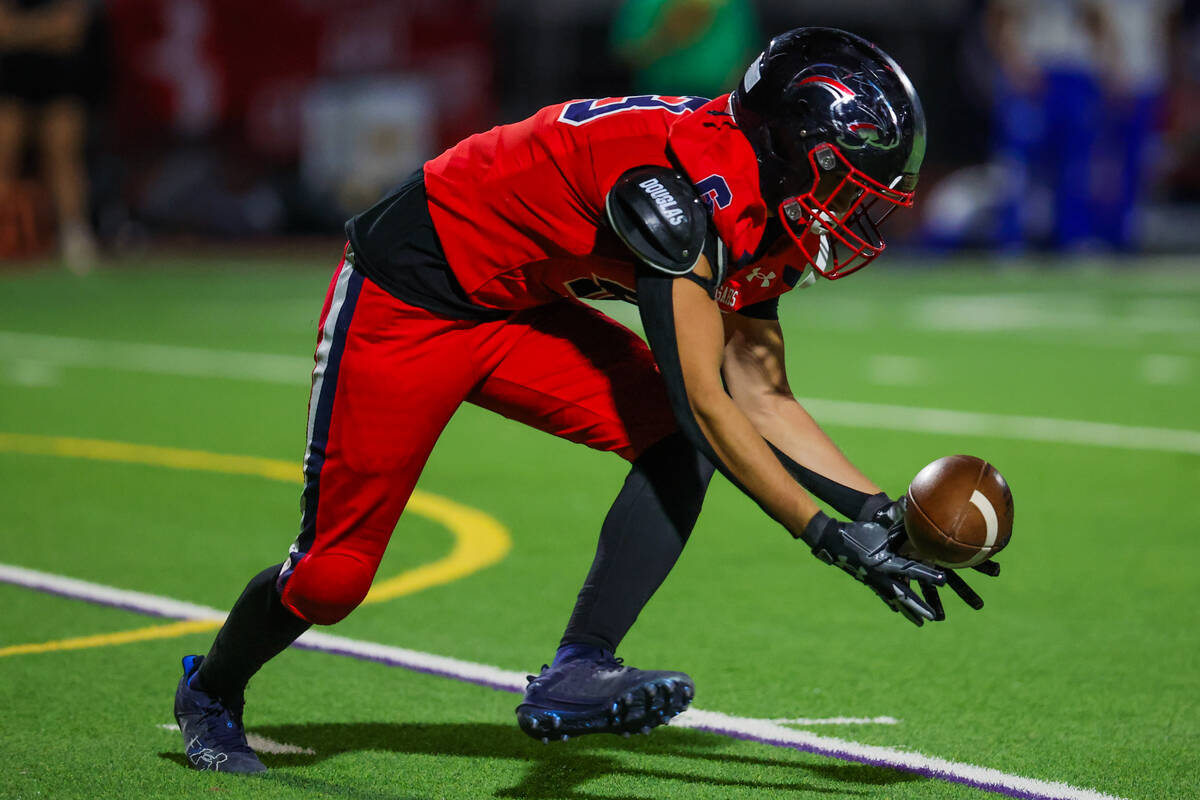 Coronado wide receiver Scott Holper (13) keeps the ball in his hands during a football game bet ...