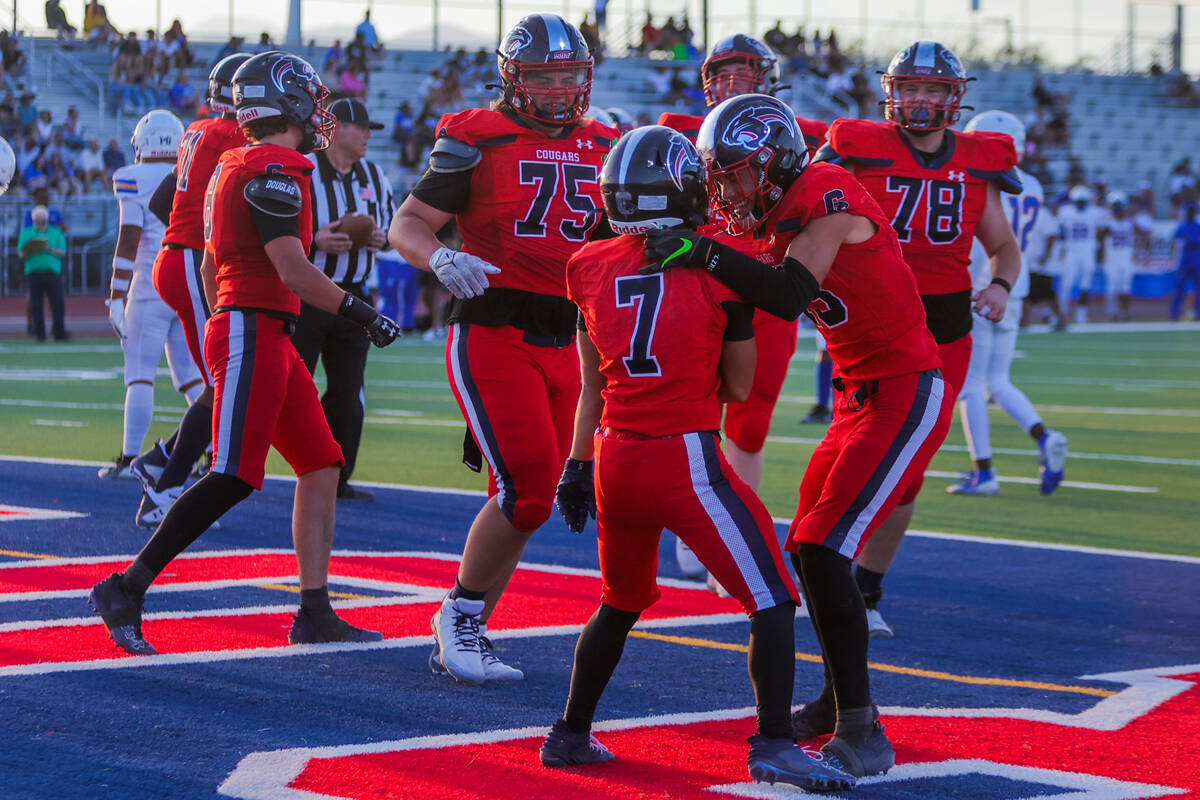 Coronado teammates Scott Holper (13) and Christian Nabong (7) celebrate a touchdown by Nabong d ...