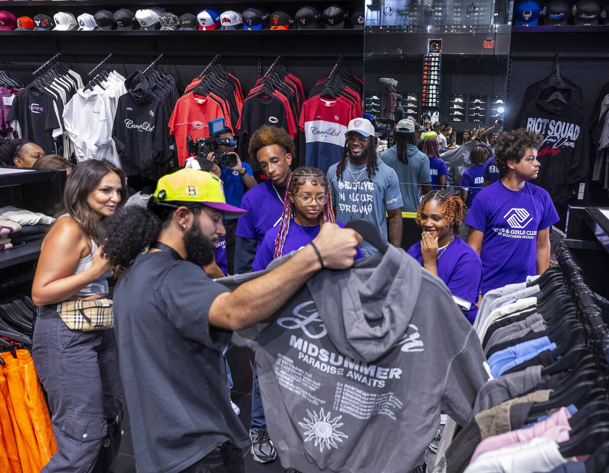 Tour guide Gio Peralte, left, shows teens from the Boys & Girls Clubs of Southern Nevada an ...