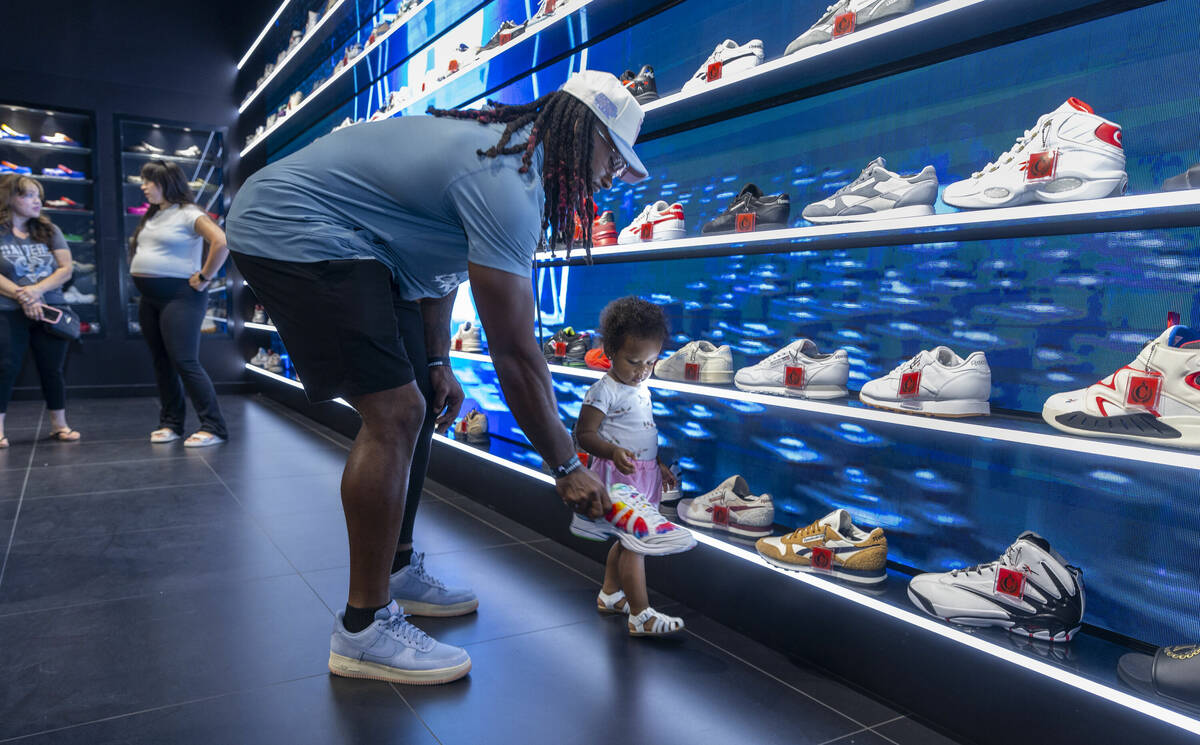 Raiders running back Alexander Mattison shows off some some popular sneakers to his daughter Al ...