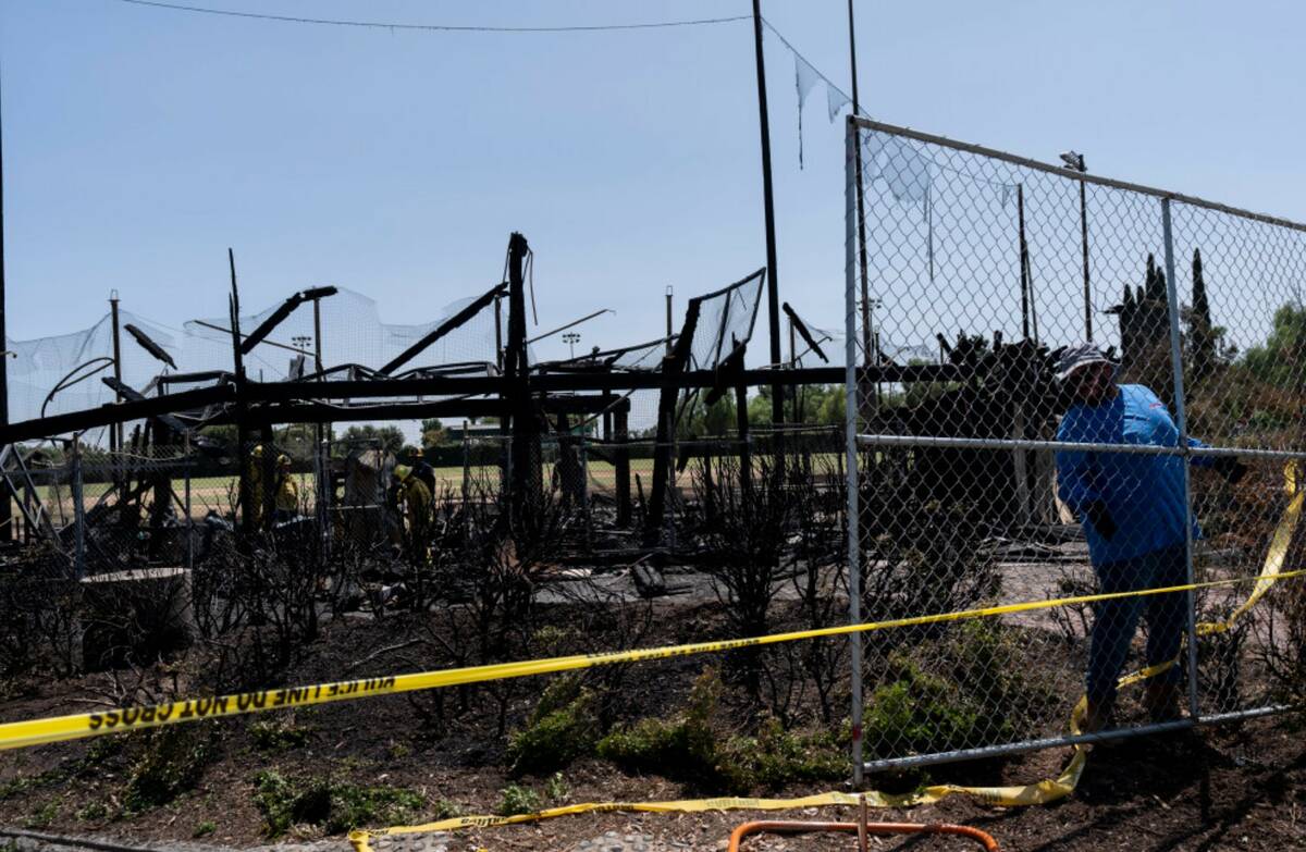 A worker sets up a fence outside Jay Littleton Ball Park, a historic baseball field that appear ...