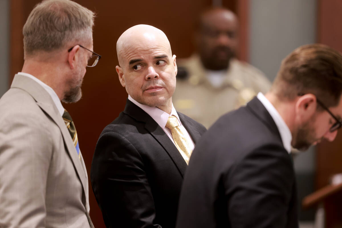 Robert Telles, center, is flanked by his attorneys Robert Draskovich, left, and Michael Horvath ...