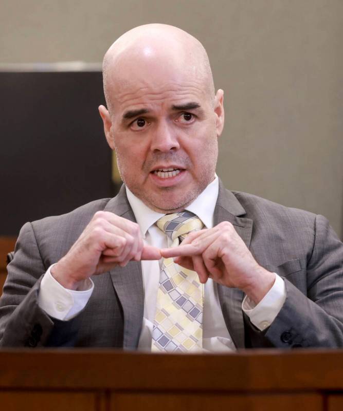 Robert Telles shows how he cut his finger while speaking to the jury from the witness stand on ...