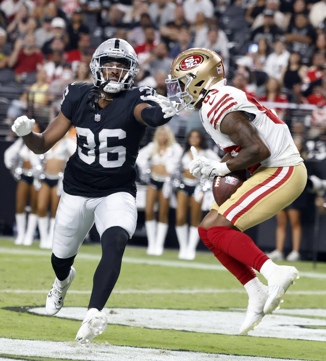 San Francisco 49ers wide receiver Jacob Cowing catches a touchdown pass as Raiders cornerback R ...