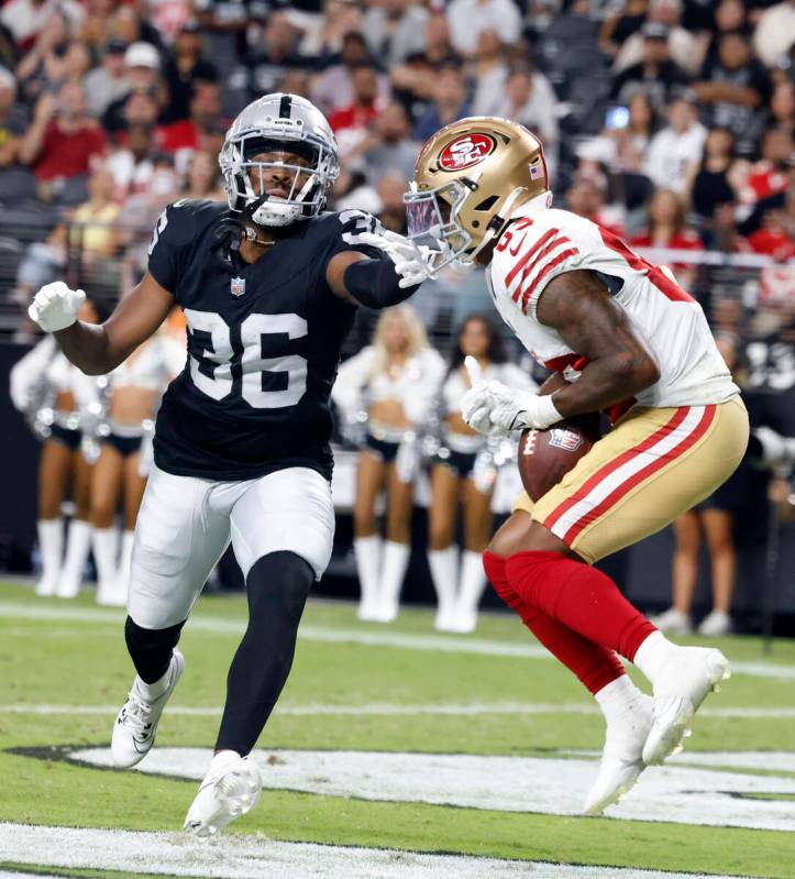 San Francisco 49ers wide receiver Jacob Cowing catches a touchdown pass as Raiders cornerback R ...