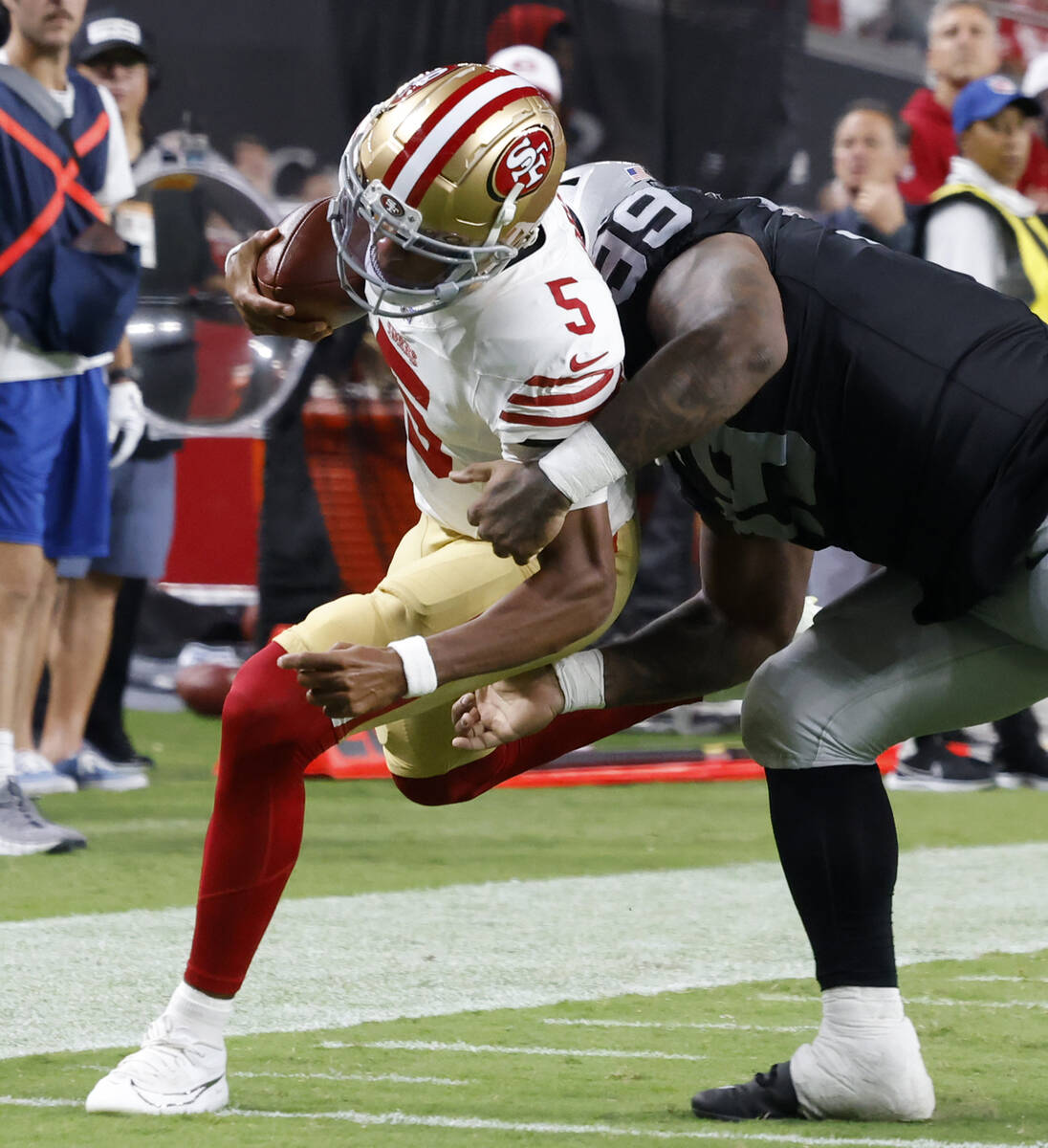 Las Vegas Raiders tight end Brock Bowers (89) sacked San Francisco 49ers quarterback Joshua Dob ...