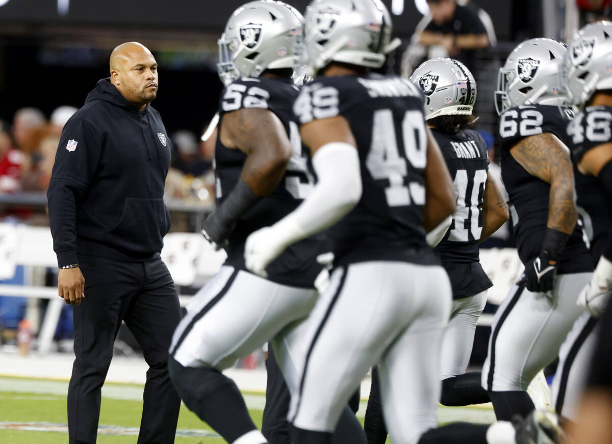 Raiders head coach Antonio Pierce watches as his players warm up to face San Francisco 49ers d ...