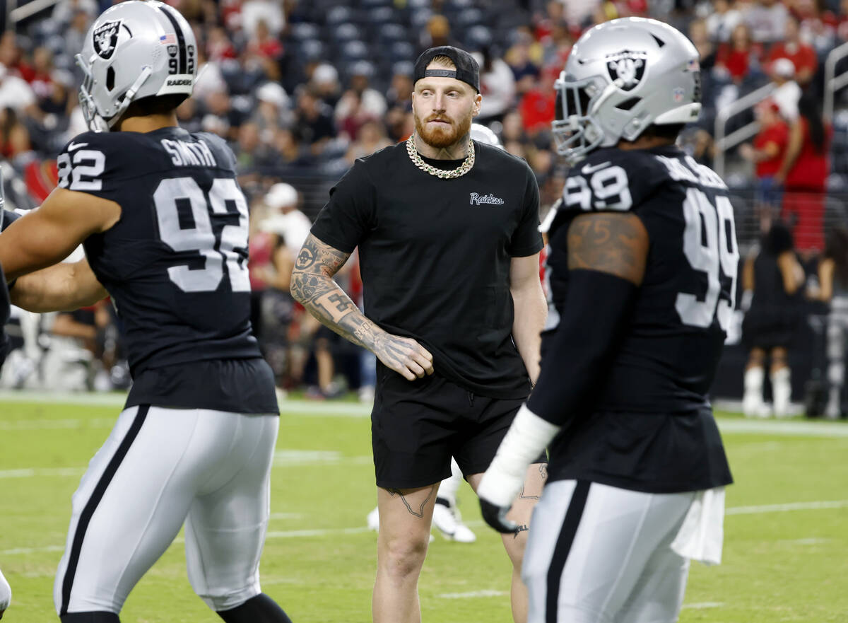 Raiders defensive end Maxx Crosby watches as his teammates warm up to face San Francisco 49ers ...