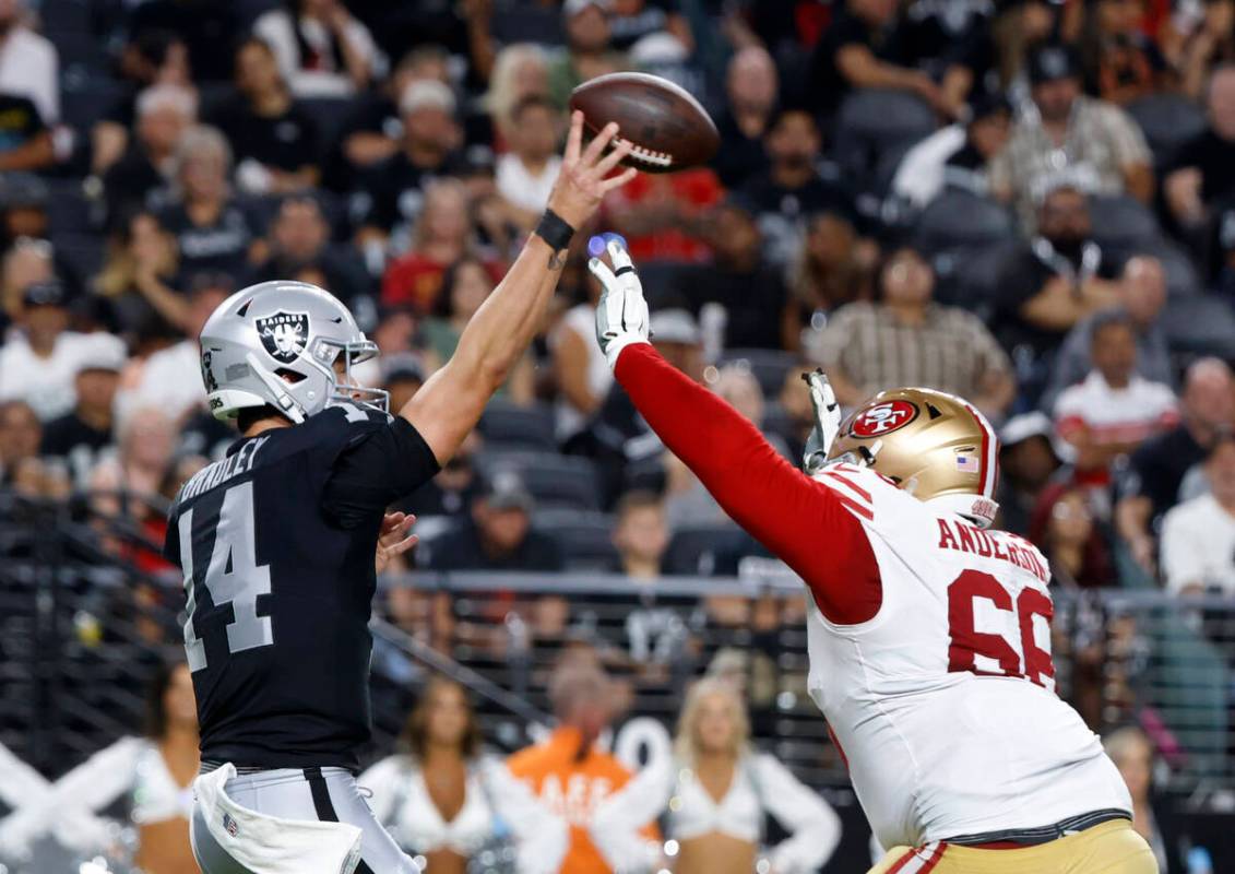 Raiders quarterback Carter Bradley (14) throws the ball under pressure from San Francisco 49ers ...