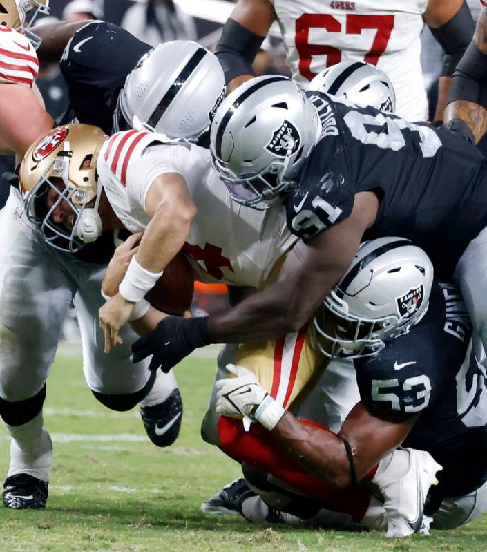 San Francisco 49ers quarterback Tanner Mordecai (4) sacked by Raiders linebacker Amari Gainer ( ...