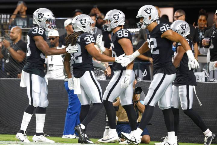 Raiders wide receiver Tyreik McAllister (32) celebrates his punt return touchdown with his team ...