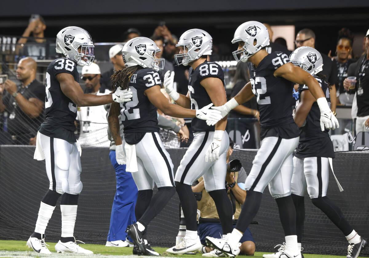 Raiders wide receiver Tyreik McAllister (32) celebrates his punt return touchdown with his team ...