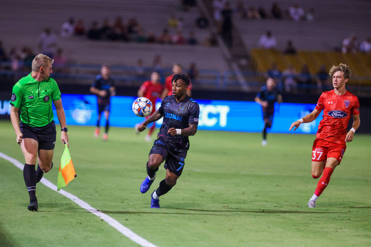 Lights FC midfielder Joseph-Claude Gyau (7) runs after the ball as a referee watches to see if ...