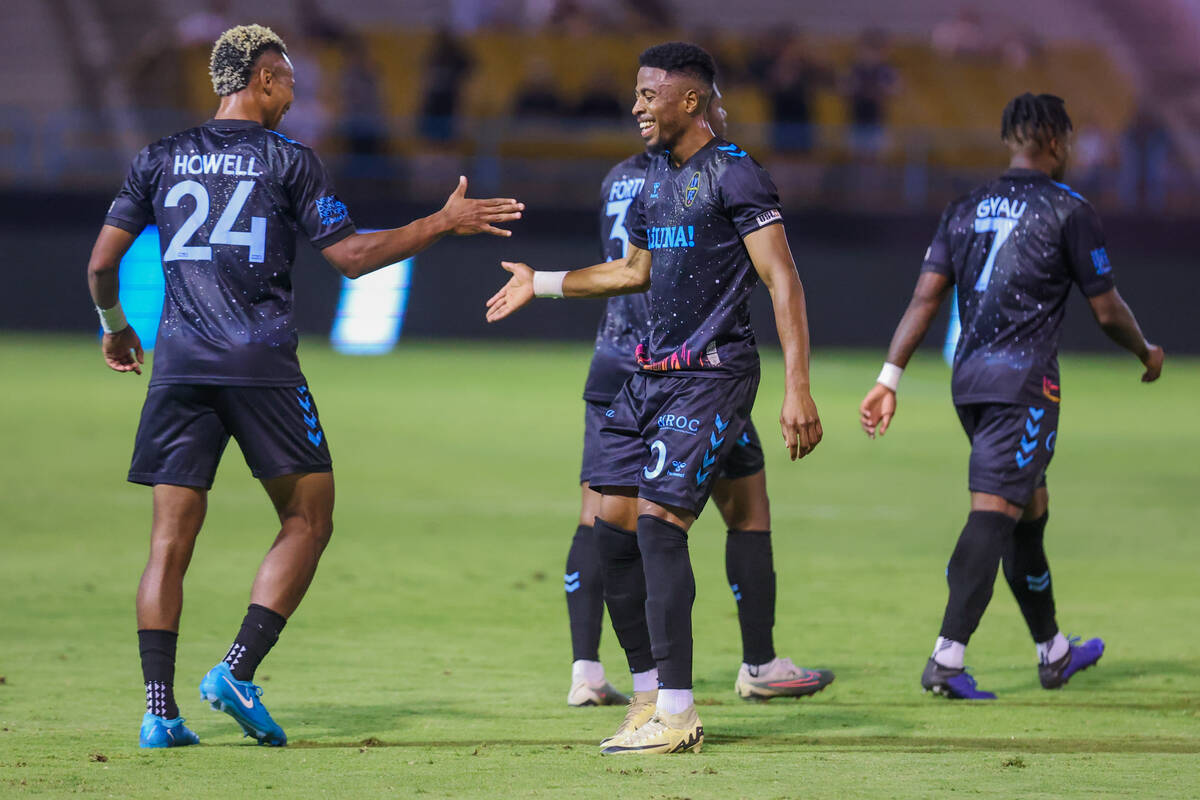 Lights FC defender Maliek Howell (24) high fives teammate Khori Bennett (90) during a soccer ga ...