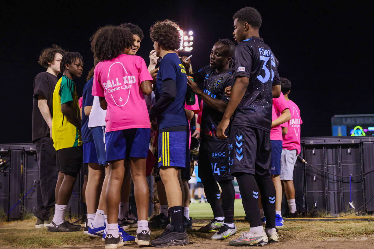 Lights FC forward Solomon Asante (14) signs autographs for fans following a soccer game between ...