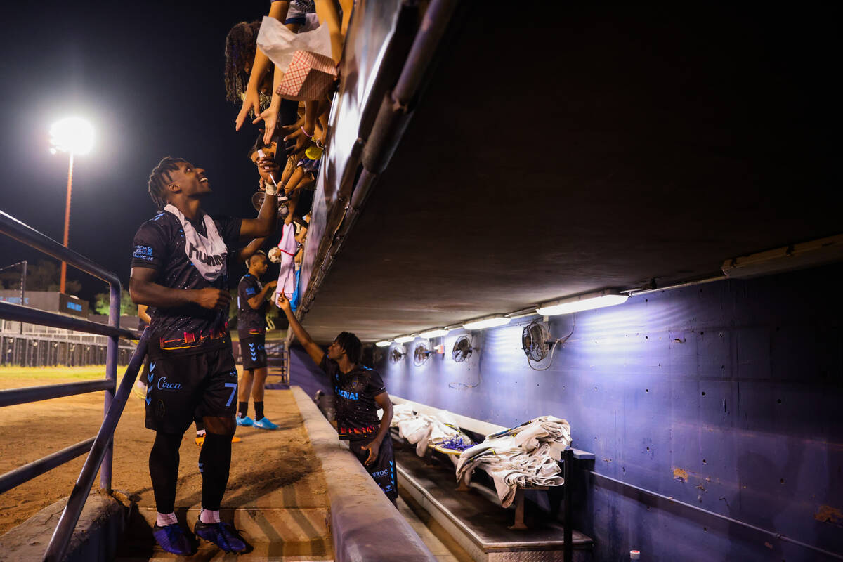 Lights FC midfielder Joseph-Claude Gyau interacts with fans as he leaves the field after a socc ...