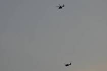 Israeli Apache helicopters fly toward northern Israel, Sunday, Aug. 25, 2024. (AP Photo/Ariel S ...