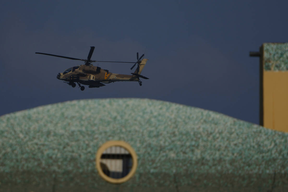 An Israeli Apache helicopter flies over Israel, Sunday, Aug. 25, 2024. (AP Photo/Ariel Schalit)