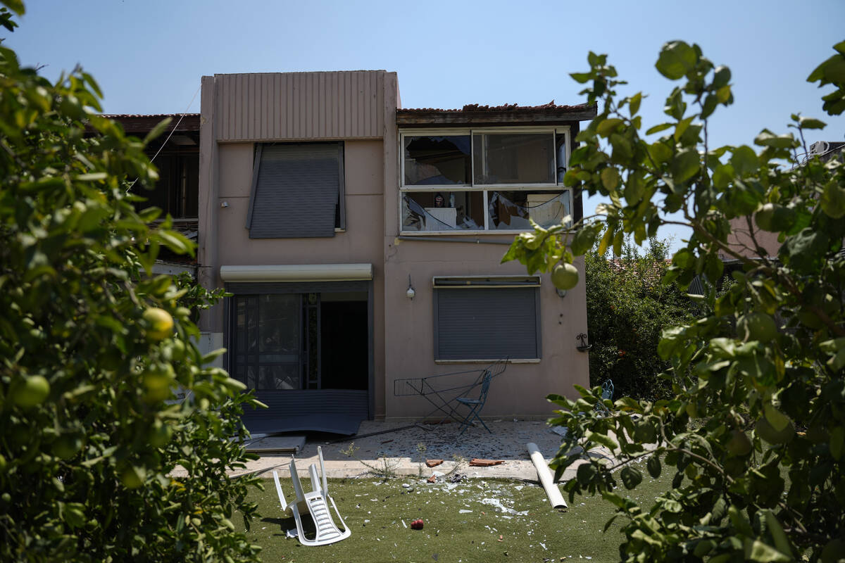 A damaged house is seen following an attack from Lebanon, in Acre, north Israel, Sunday, Aug. 2 ...