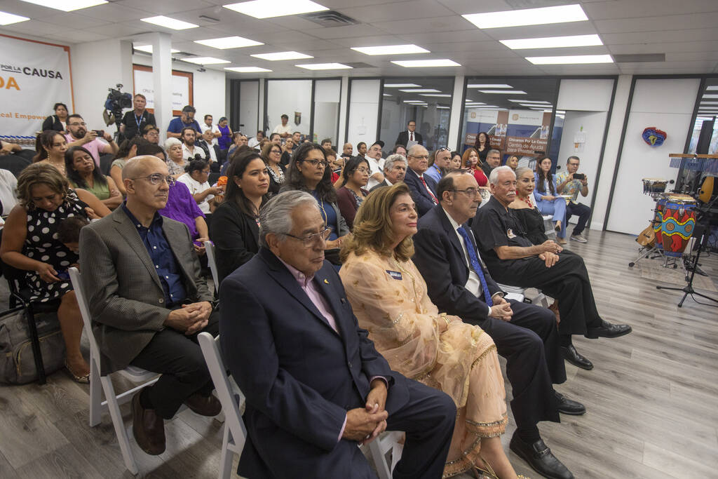 Members of the crowd listen to different speakers during the unveiling of the bust sculpture of ...