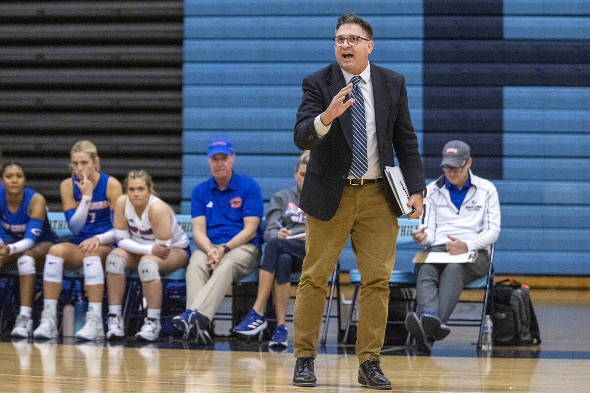 Bishop Gorman Head Coach Gregg Nunley talks to his players before a serve during the volleyball ...