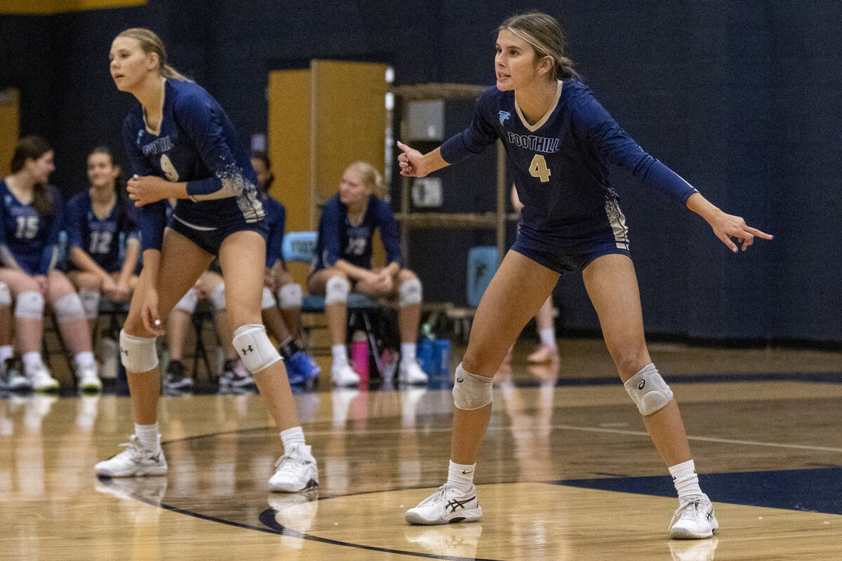 Foothill freshman Bryn Neibaur (9) and senior Madison Holmes (4) prepare for a serve during the ...