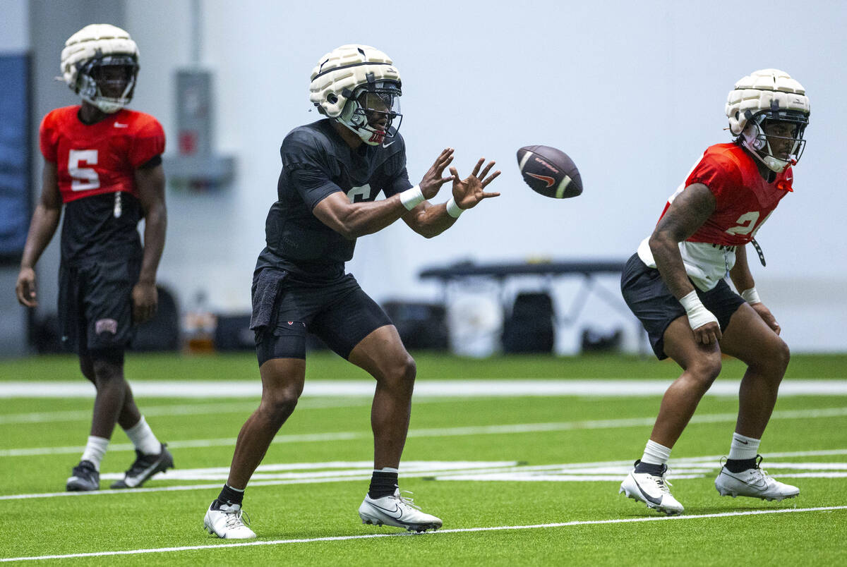 UNLV quarterback Hajj-Malik Williams (6) receives a hike during football practice at the Interm ...