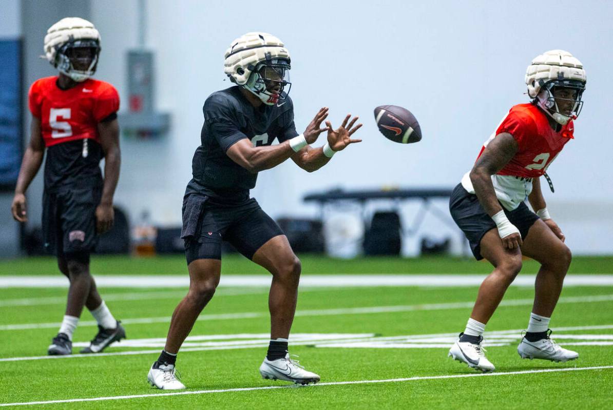 UNLV quarterback Hajj-Malik Williams (6) receives a hike during football practice at the Interm ...