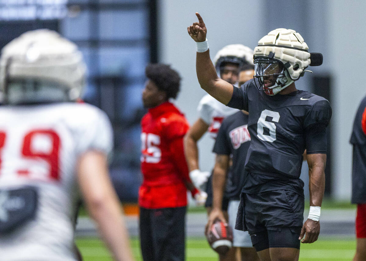 UNLV quarterback Hajj-Malik Williams (6) signals to a receiver during football practice at the ...