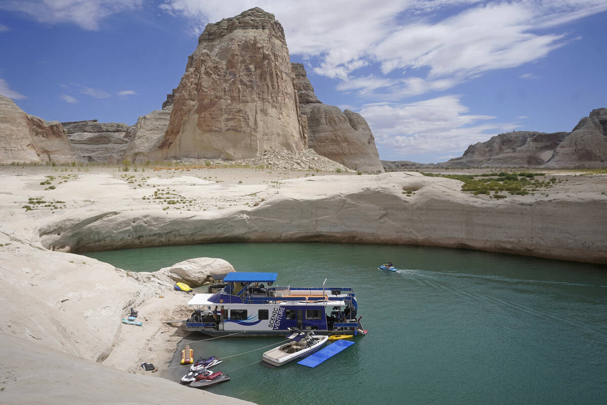 A houseboat rests in a cove at Lake Powell near Page, Ariz., in 2021. (AP Photo/Rick Bowmer)