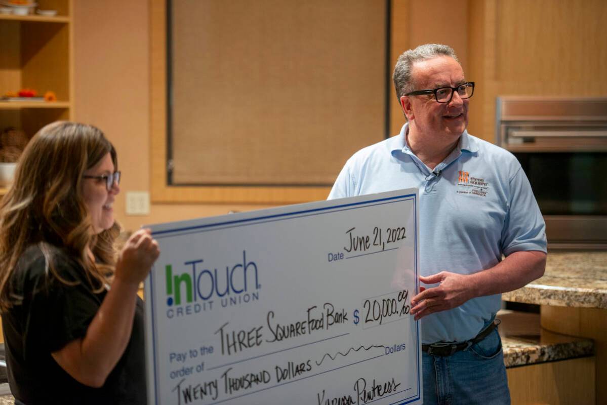 Karessa Pewtress of InTouch Credit Union, left, presents a check for $20,000 to Three Square Fo ...