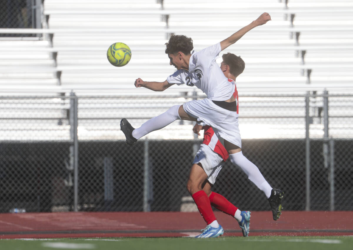 Cimarron-Memorial's Said Lopez (21) kicks the ball out against Coronado's Gavin Flickinger duri ...