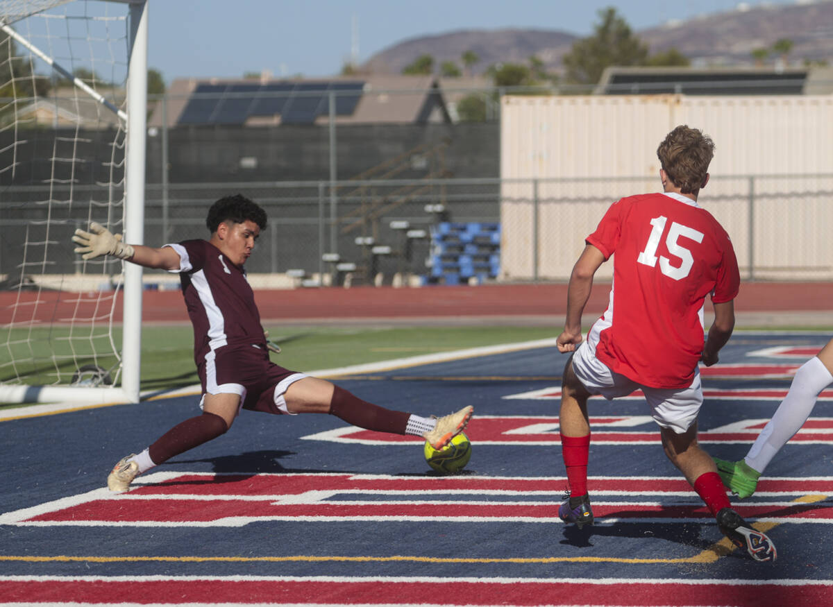 Coronado's defender Ben Aronow (15) kicks the ball past Cimarron-Memorial goalkeeper Dylan Cros ...