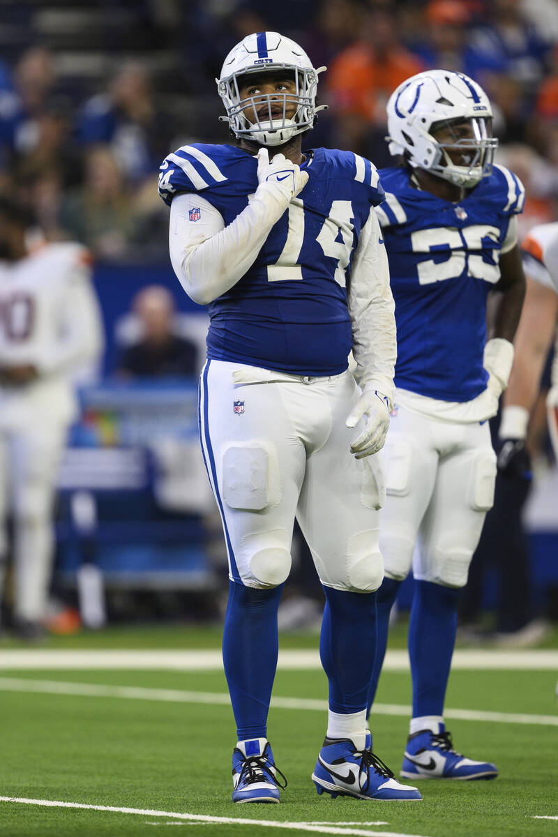 Indianapolis Colts defensive tackle Jonah Laulu (74) looks up at a replay during an NFL footbal ...