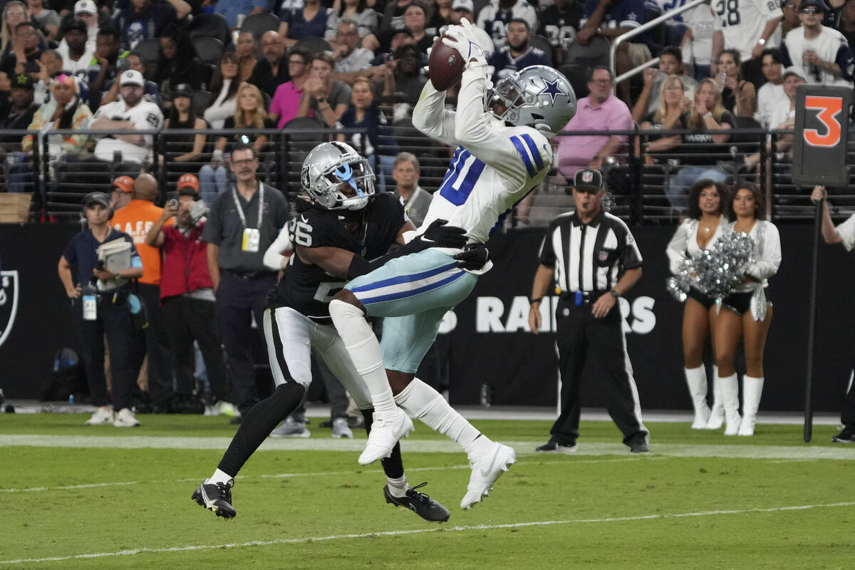 Dallas Cowboys wide receiver Racey McMath (80) makes a catch over Las Vegas Raiders cornerback ...