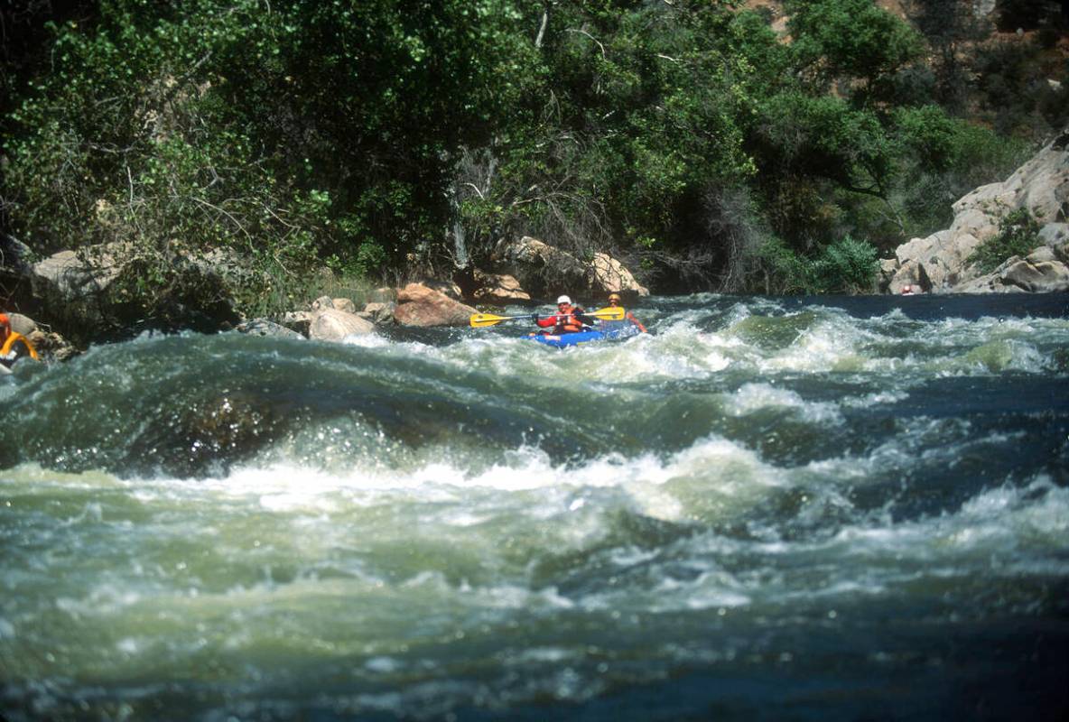 Scouting the rapids for whitewater riverboarding in the Kern River in the Sequoia National Fore ...